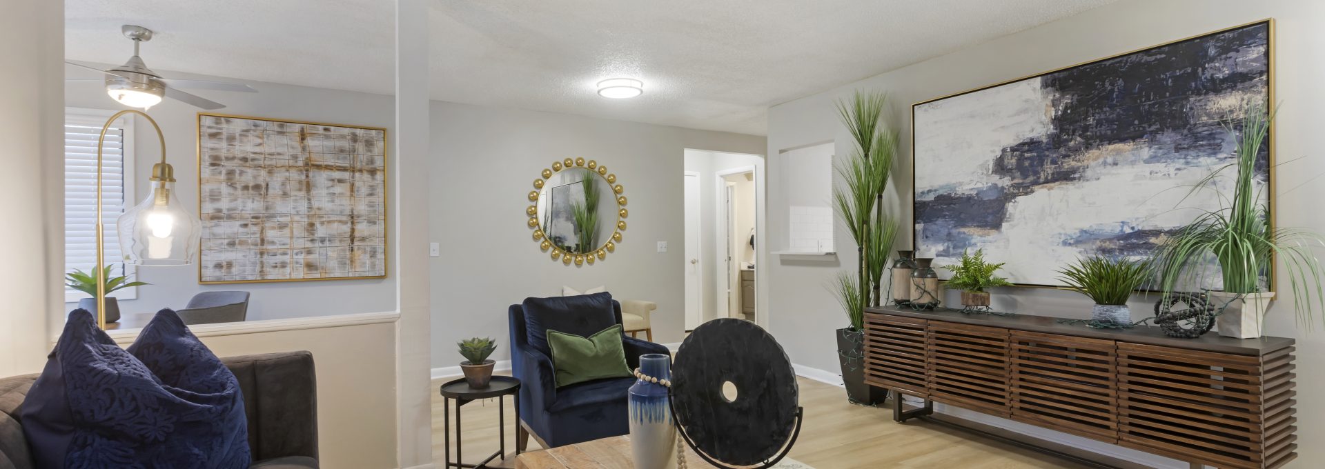 a living room with a couch, coffee table and fan at The Terra at Norcross