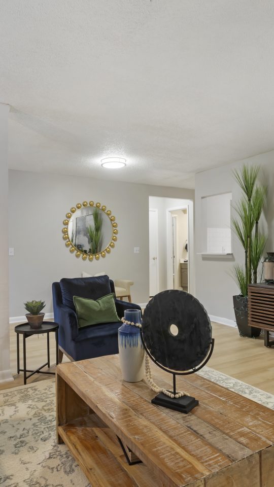 a living room with a couch, coffee table and fan at The Terra at Norcross